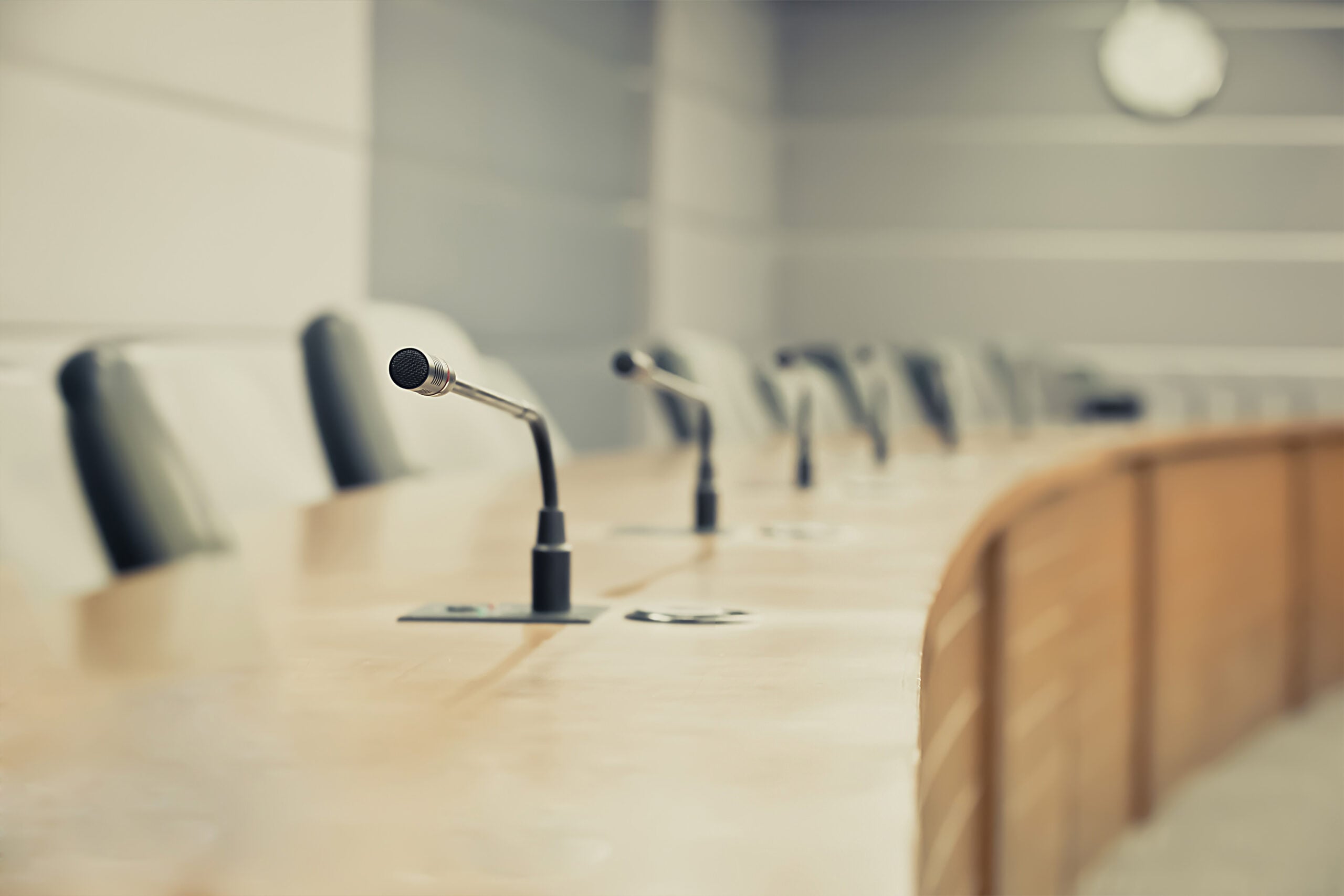 Microphones and seats in a public meeting room where city commission meetings are held.